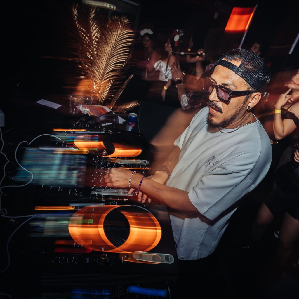 Micky Perú performing a high-energy DJ set during Día de Muertos in Amsterdam with The Latin Experience.