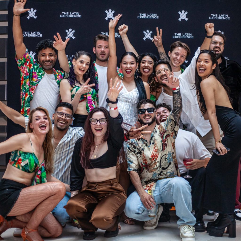 Group of artists, guests, and organizers at The Latin Experience event photocall in Amsterdam.