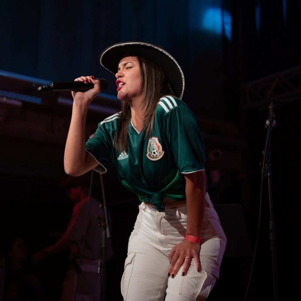 Danisha performing urban rhythm covers at The Mexican Experience, showcasing her versatility and energy.